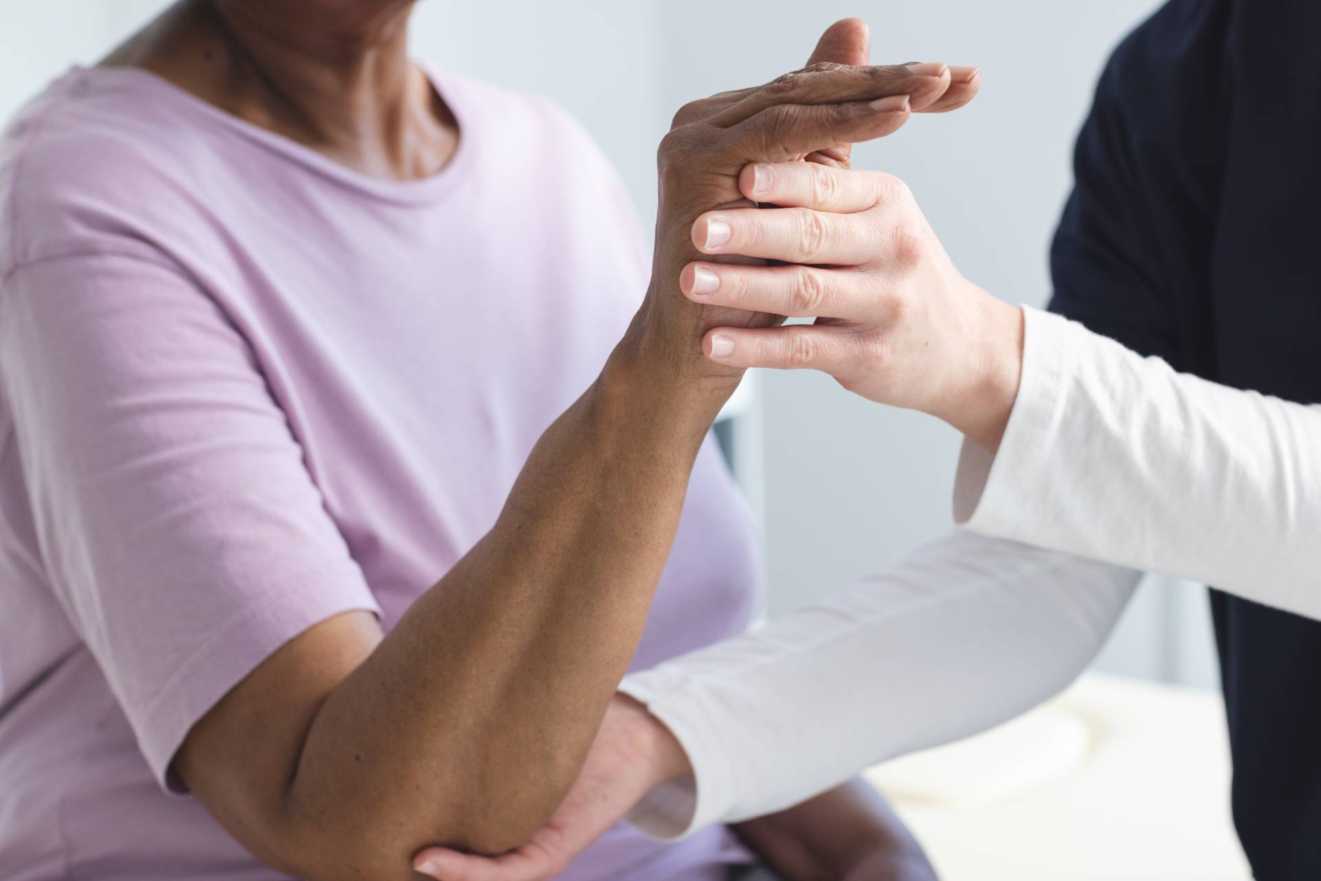 diverse-senior-female-patient-exercising-hand-and